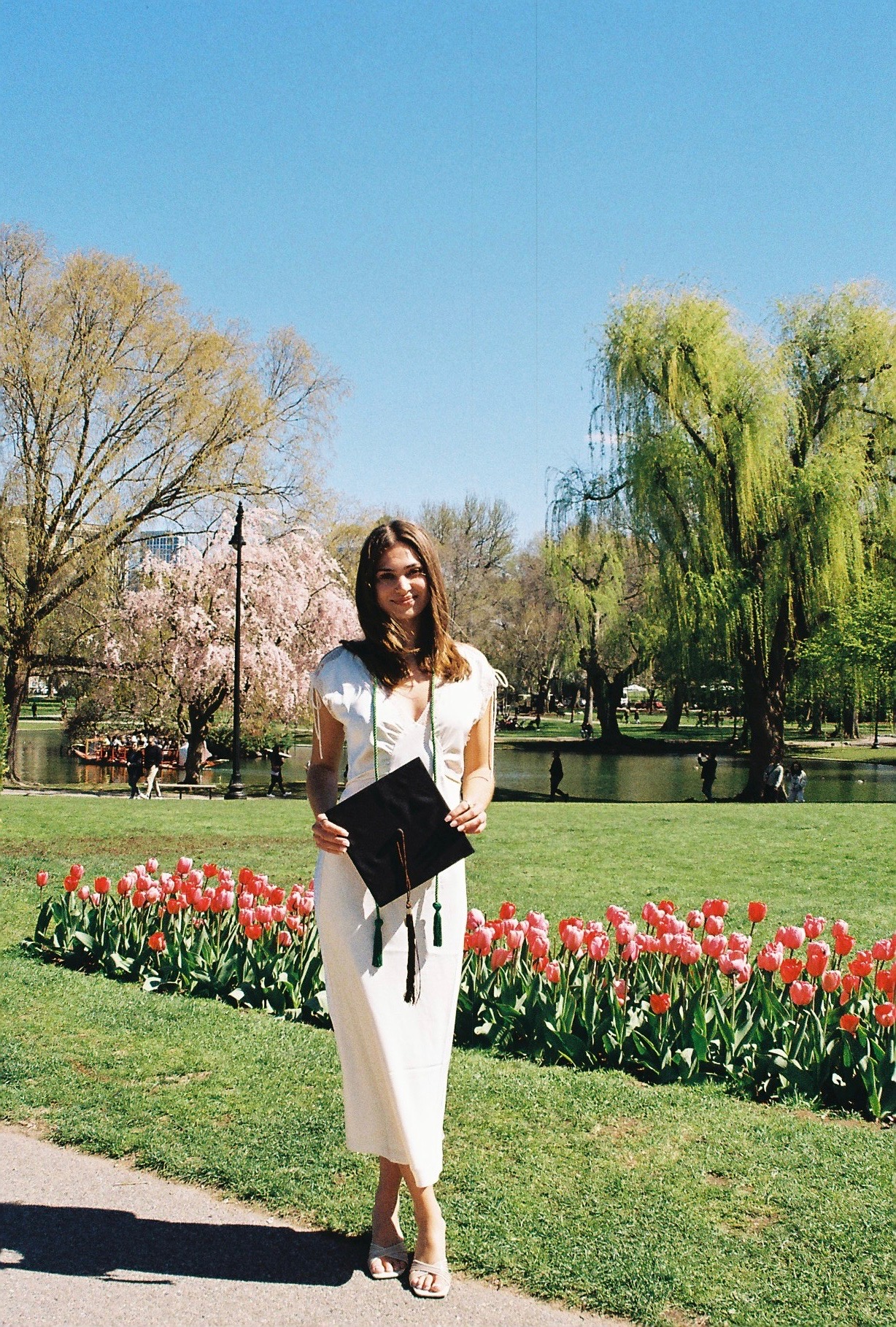 Giulia standing among tulips in a Boston park.